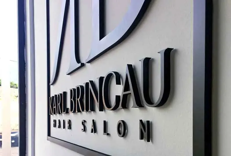Brushed metal 3D lettering mounted on a salon fascia in Malta